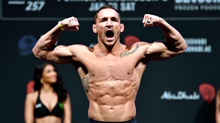 UFC's Michael Chandler flexes at a weight-in